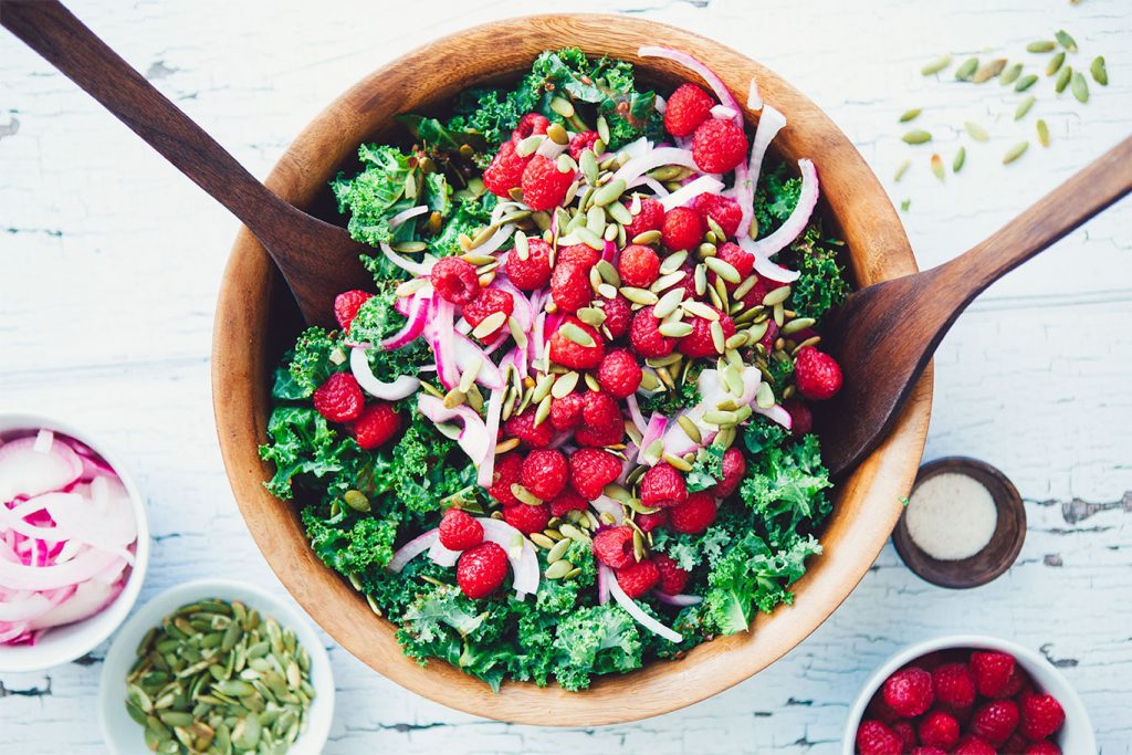 This Winter Kale Salad with Raspberry Vinaigrette recipe is easy to make, healthy and totally delicious. A crowd pleaser that truly goes with any dish!