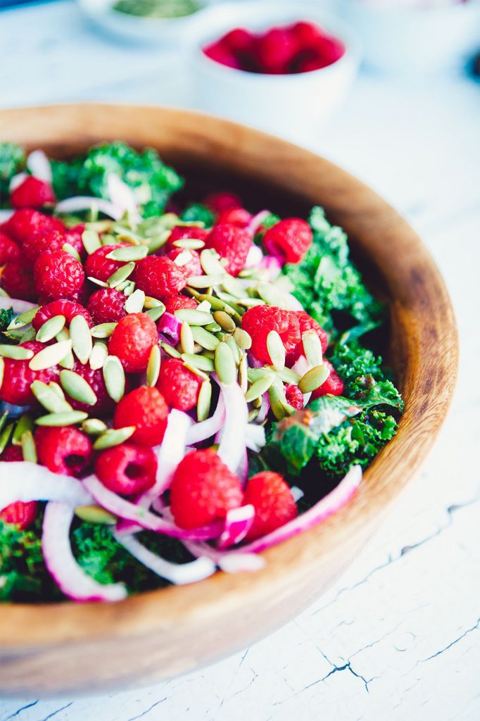 This Winter Kale Salad with Raspberry Vinaigrette recipe is easy to make, healthy and totally delicious. A crowd pleaser that truly goes with any dish!