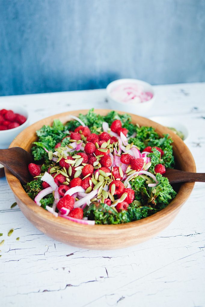 This Winter Kale Salad with Raspberry Vinaigrette recipe is easy to make, healthy and totally delicious. A crowd pleaser that truly goes with any dish!