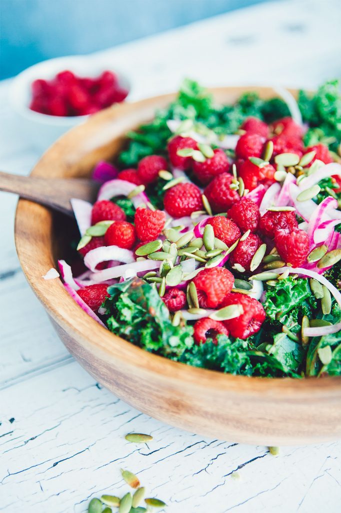 This Winter Kale Salad with Raspberry Vinaigrette recipe is easy to make, healthy and totally delicious. A crowd pleaser that truly goes with any dish!